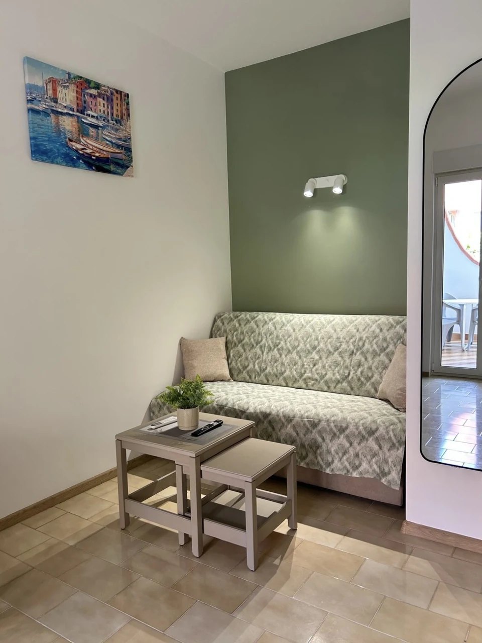 The sofa against the olive wall
